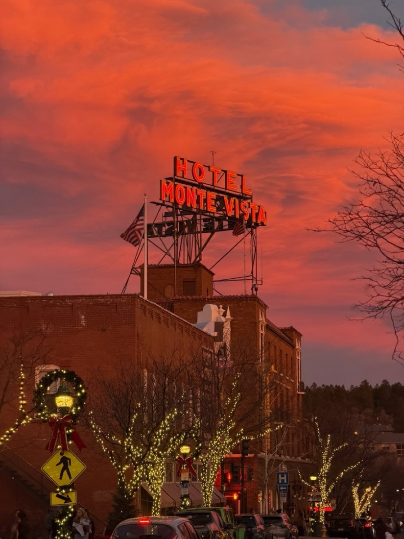 The Hotel Monte Vista rooftop neon sign lit against a sunset sky in downtown Flagstaff