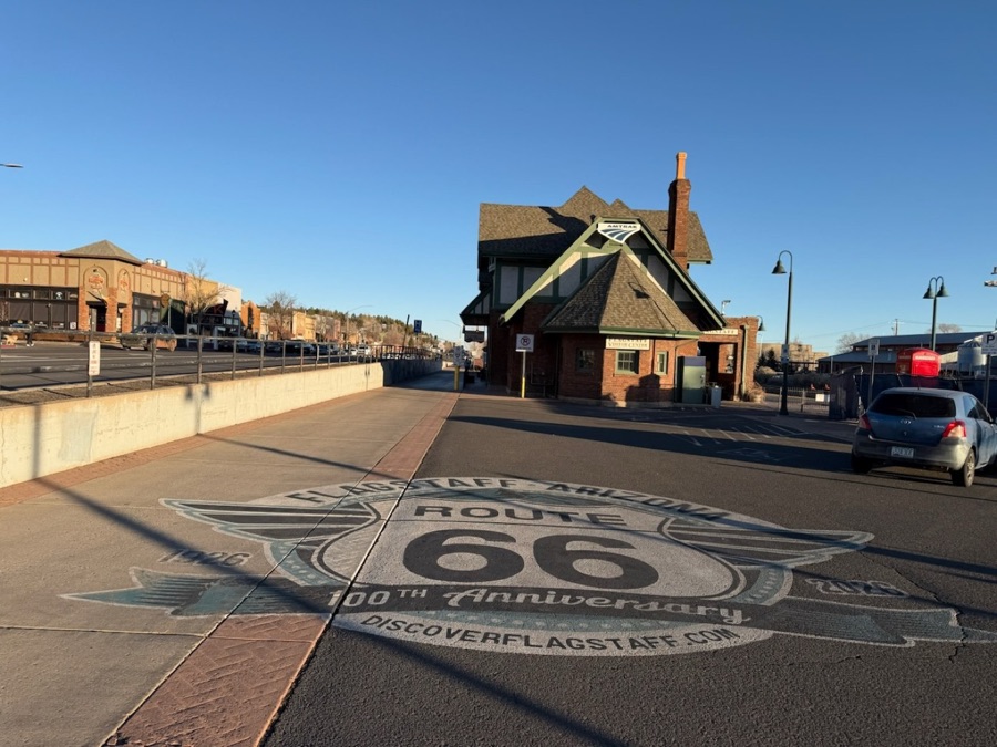 The Route 66 centennial medallion set in the sidewalk at the Flagstaff train depot
